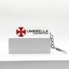1949d880-04c9-4461-8dda-ec5e733773bc.jpg سلسلة مفاتيح Umbrella Corporation – رمز Biohazard الشهير