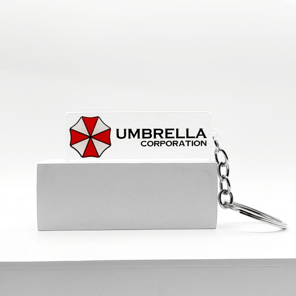 1949d880-04c9-4461-8dda-ec5e733773bc.jpg سلسلة مفاتيح Umbrella Corporation – رمز Biohazard الشهير