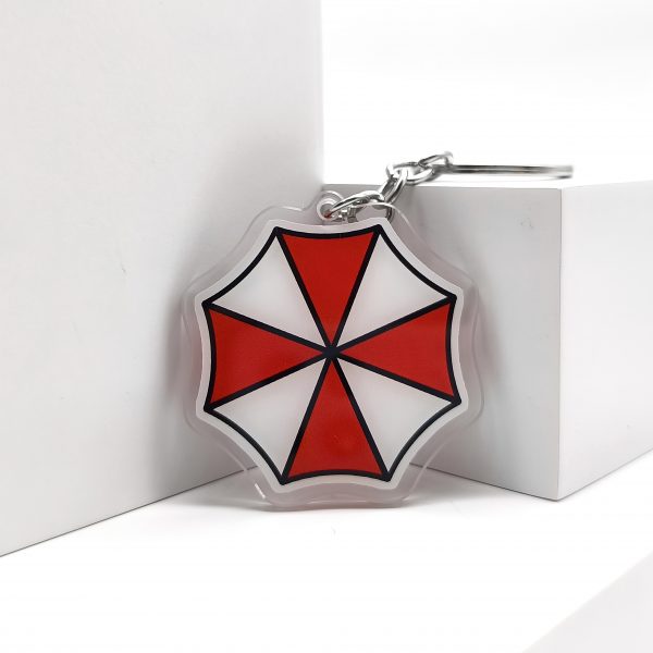 38275307-c90c-4426-b7c6-6de377eb12f0.jpg سلسلة مفاتيح Umbrella Corporation – رمز Biohazard الشهير
