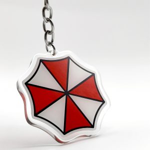 3900571057f6be1dfea07fec0a4cdd84_1732518589245.jpg سلسلة مفاتيح Umbrella Corporation – رمز Biohazard الشهير