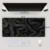 807909f7-a84a-475d-be6c-31a4a8f07780.jpg Extra-Large Gaming Mouse Pad – تصميم أنيق أبيض وأسود لعشاق الـSetup النظيف